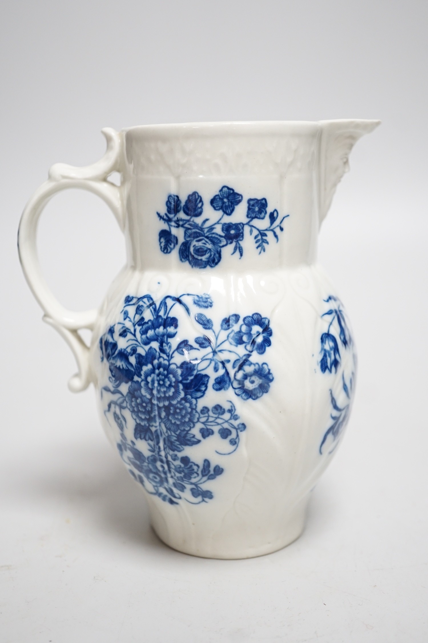 An 18th century Caughley mask jug printed with bouquets, C mark to base, 14.5cms high